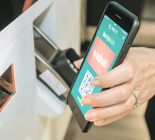boy scanning his phone in a McDonalds store